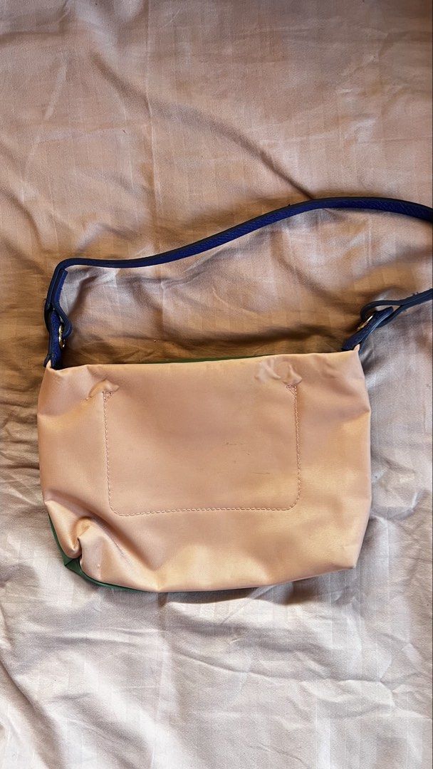 Longchamp (Category: Cross-body Bags) located in Taguig. Submitted by declutter67 (Listing ID 1443967423, Image 1). Description: - Cute Longchamp shoulder bag - Reversible design: Green on one side, Pink on the other - Blue leather strap and trim - Gold zipper detail - Great for everyday use - Plenty of space inside for essentials.