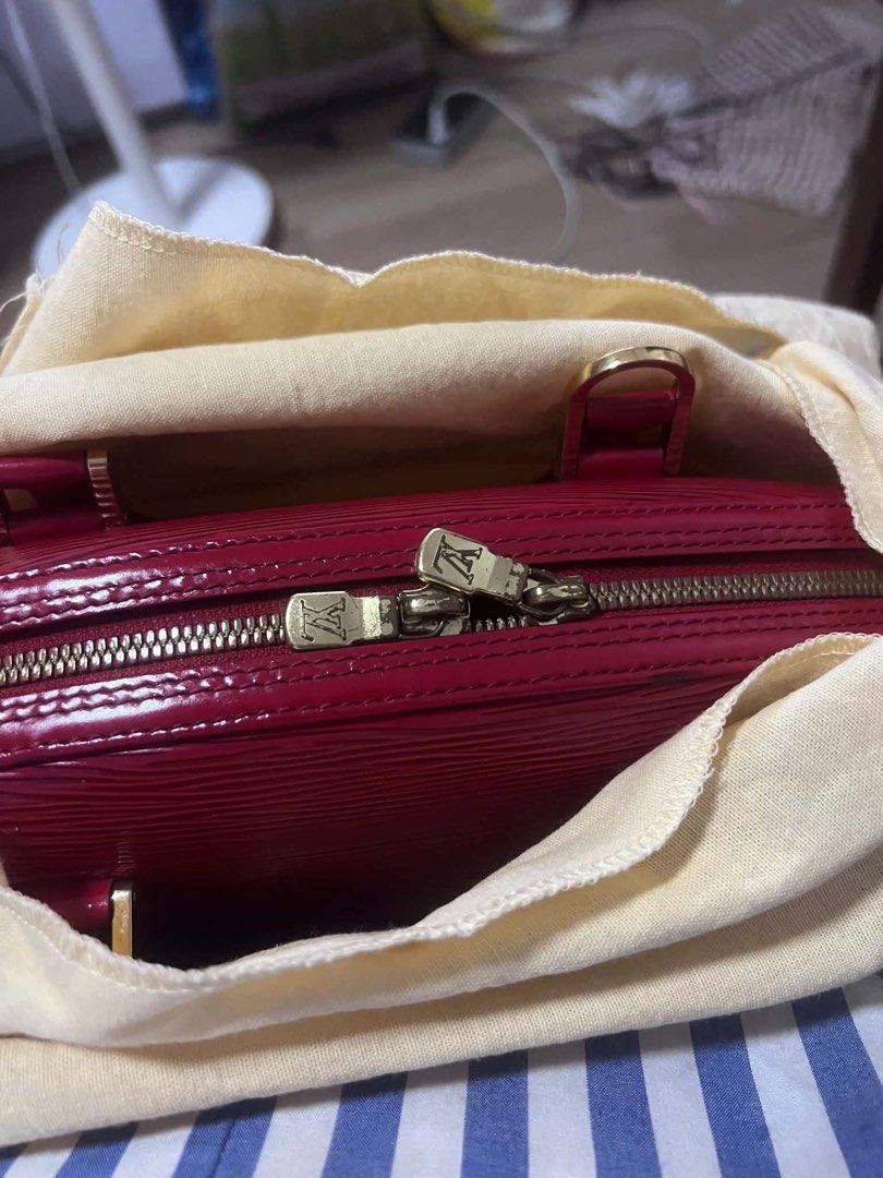 Louis Vuitton Epi Leather Red Handbag (Category: Luxury Bags & Wallets) located in Pasig City. Submitted by cecilececile4361 (Listing ID 1443954086, Image 2). Description: - Authentic Red Louis Vuitton Handbag - Durable Epi Leather - Elegant Gold Hardware - Secure Zipper Closure - Convenient Interior Pocket - Sturdy Handles for Everyday Use - Versatile for Casual or Formal Occasions - Comes with Original Dust Bag.
