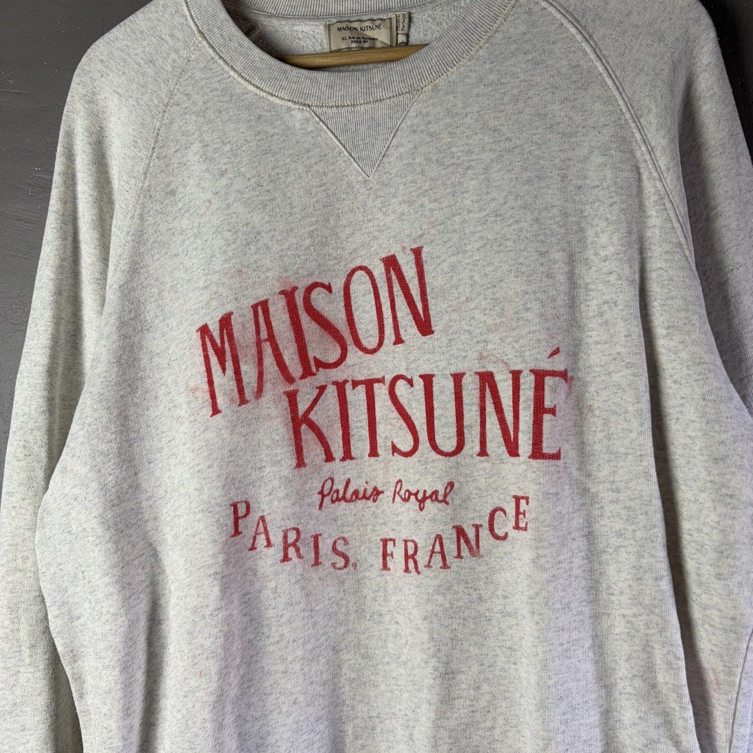 Maison Kitsune Gray Sweatshirt (Category: Luxury Apparel) located in Manila. Submitted by yourtherapist_ (Listing ID 1444032851, Image 2). Description: Maison Kitsune Gray Sweatshirt Large Authentic Good condition With flaw Red print has spread/considered as stain Measurements (inches) Width - 23” Length - 28” 850.