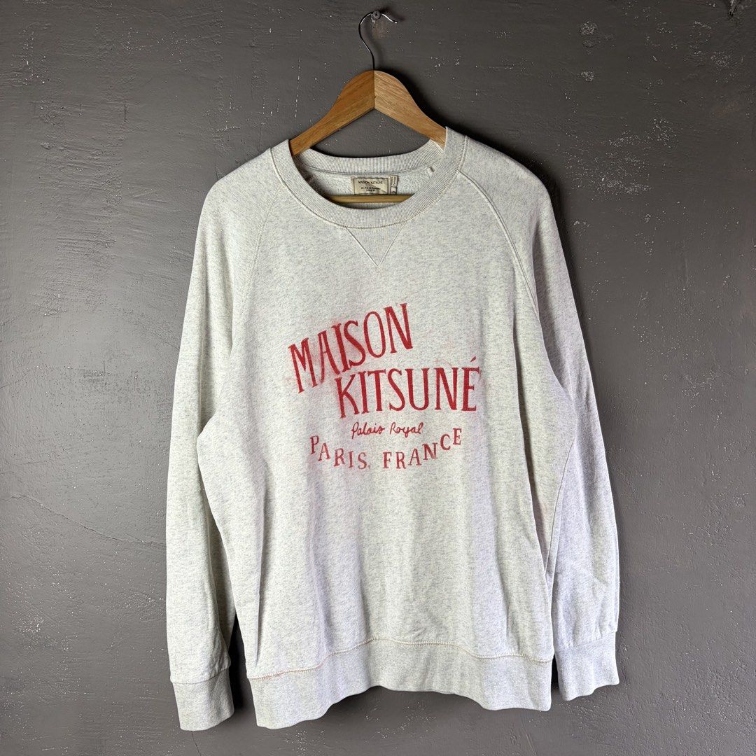 Maison Kitsune Gray Sweatshirt (Category: Luxury Apparel) located in Manila. Submitted by yourtherapist_ (Listing ID 1444032851, Image 1). Description: Maison Kitsune Gray Sweatshirt Large Authentic Good condition With flaw Red print has spread/considered as stain Measurements (inches) Width - 23” Length - 28” 850.
