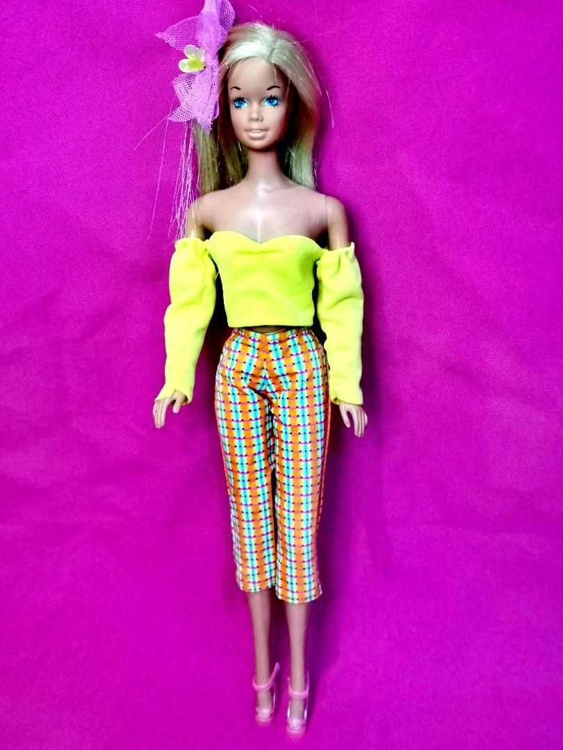 Malibu vintage Barbie (Category: Kids Toys) located in Quirino. Submitted by Carlisle_27 (Listing ID 1443961444, Image 1). Description: - Vintage Barbie doll - Outfit: Yellow off-the-shoulder top and colorful plaid capri pants - Accessories: Pink heels and floral hair accessory - Ideal for collectors or play.