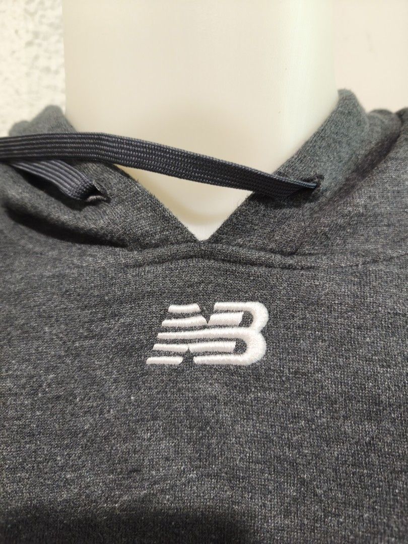 New Balance Grey Hoodie (Category: Hoodies) located in Iloilo. Submitted by daddy_declutter (Listing ID 1443930498, Image 2). Description: - Grey New Balance hoodie - Classic NB logo embroidered on chest - Features drawstring hood - Includes front pocket - Measurements: 26" width, 29" length - Ideal for casual everyday wear.