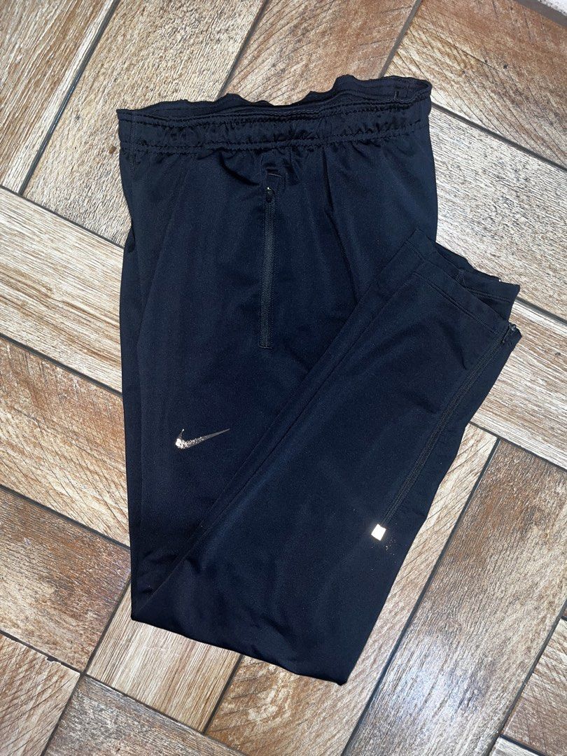 Nike Dri-FIT Black Track Running Pants Size S (Category: Activewear) located in Makati City. Submitted by gabrayco (Listing ID 1444091939, Image 2). Description: - Black Nike Dri-FIT pants - Ideal for running or training - Front zippered pocket for secure storage - Reflective details on the back of the legs for visibility - Elastic waistband with drawstring for a comfortable, adjustable fit - Made in Cambodia.