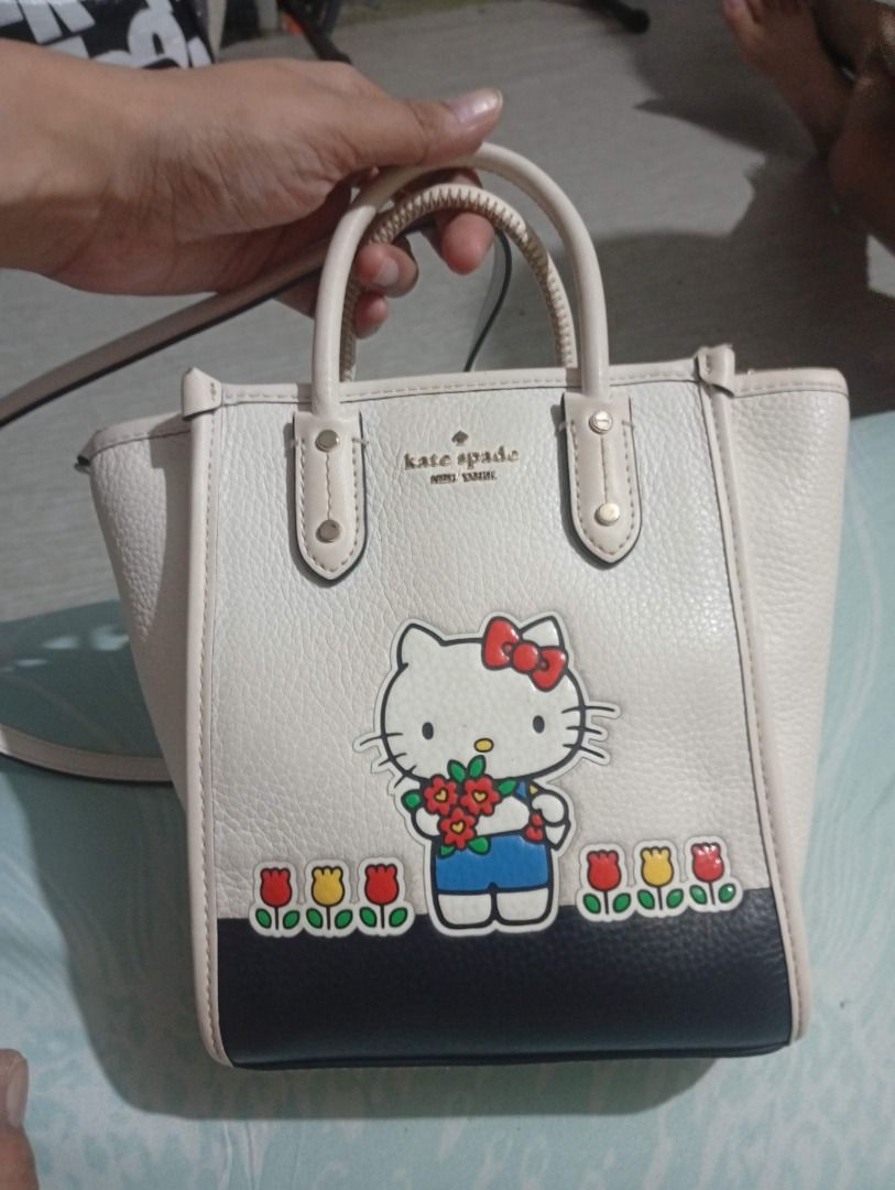 Original Kate Spade x Hello Kitty Leather Tote Bag (Category: Tote Bags) located in Caloocan City. Submitted by shadmidnight1984 (Listing ID 1444045485, Image 1). Description: - White leather tote bag - Collaboration: Kate Spade x Kitty - Adorable Kitty and tulip design - Top handles - Detachable crossbody strap - Interior zip pocket - Ideal for everyday use or as a fun statement piece Free shipping outside Cebu City.