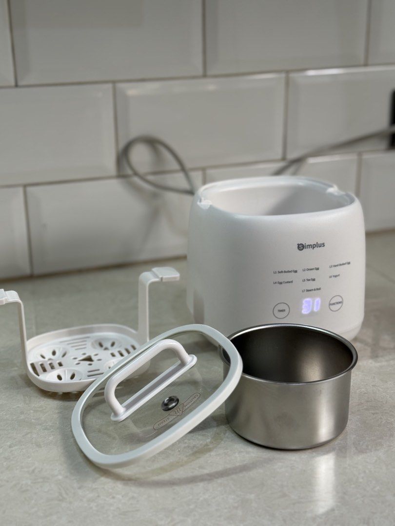 ORIGINAL Simplus Egg Cooker Multifunctional Egg Cooker 7 Modes 24h Timer Touch Control Digital Display (Brandnew/ Unboxed) (Category: Cookware & Accessories) located in Valenzuela. Submitted by homediary.ph (Listing ID 1444005191, Image 2). Description: - Cooks eggs 7 ways: soft-boiled, hard-boiled, onsen, custard, tea eggs, yogurt, steam & boil. - Features a digital display for precise cooking time. - Comes with a steaming rack and stainless ste