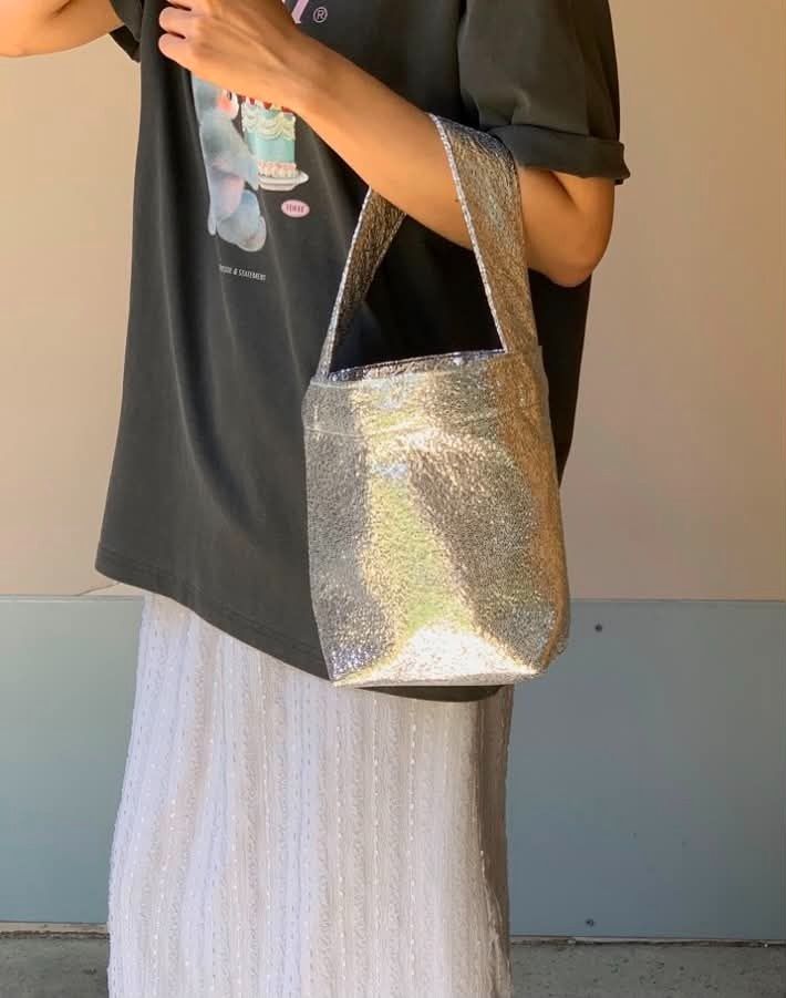 ORNOOR Cotton Silver Sequin Bucket Bag (Category: Purses & Pouches) located in Quezon City. Submitted by astargeaaa (Listing ID 1444020798, Image 2). Description: - Super cute silver sequin bucket bag - Sparkly material catches the light beautifully - Single strap for comfortable carrying - Secure snap closure inside - Ideal for night outs or adding a touch of glam to any outfit - Small and stylish accessory - ORNOOR Korean Brand.