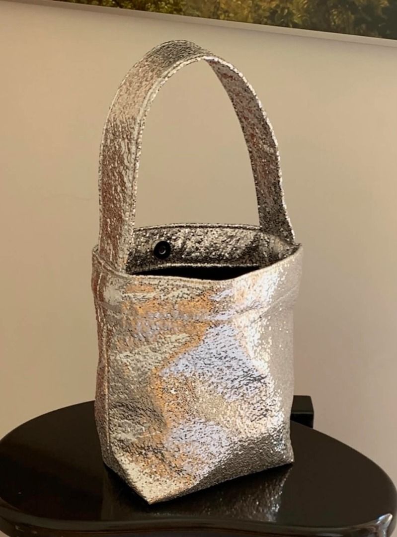 ORNOOR Cotton Silver Sequin Bucket Bag (Category: Purses & Pouches) located in Quezon City. Submitted by astargeaaa (Listing ID 1444020798, Image 1). Description: - Super cute silver sequin bucket bag - Sparkly material catches the light beautifully - Single strap for comfortable carrying - Secure snap closure inside - Ideal for night outs or adding a touch of glam to any outfit - Small and stylish accessory - ORNOOR Korean Brand.