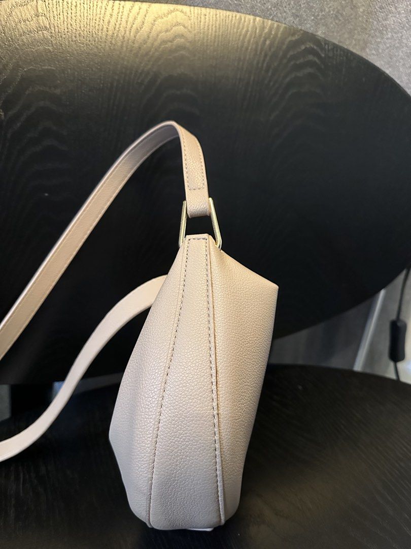 POLENE NUMERO Neuf Bag (Category: Luxury Bags & Wallets) located in Muntinlupa City. Submitted by zanne426 (Listing ID 1444055965, Image 2). Description: - Light beige Polene bag - Elegant crescent moon shape - Textured leather finish - Adjustable strap for comfort - Secure magnetic snap closure - Convenient small inner pocket - Ideal everyday bag, fits all your essentials PU material made in Thailand.