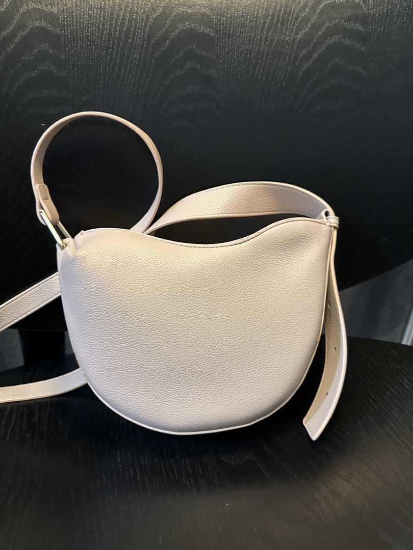 POLENE NUMERO Neuf Bag (Category: Luxury Bags & Wallets) located in Muntinlupa City. Submitted by zanne426 (Listing ID 1444055965, Image 3). Description: - Light beige Polene bag - Elegant crescent moon shape - Textured leather finish - Adjustable strap for comfort - Secure magnetic snap closure - Convenient small inner pocket - Ideal everyday bag, fits all your essentials PU material made in Thailand.