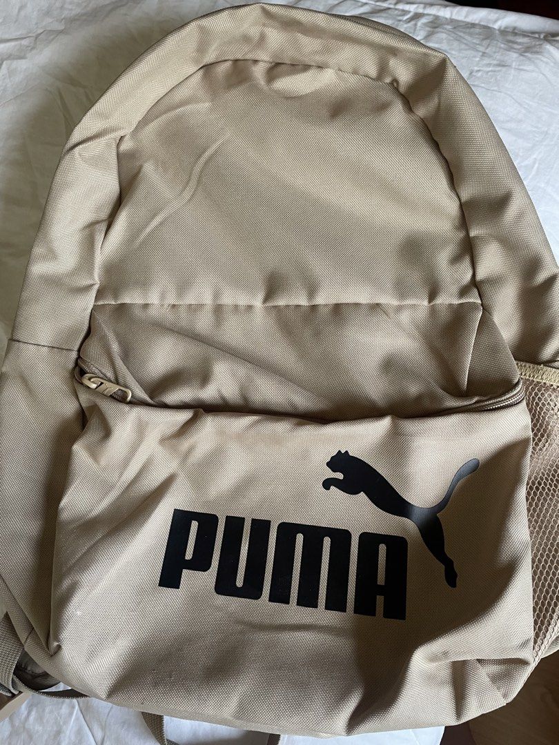 Puma Backpack Tan Beige (Category: Backpacks) located in Las Pinas. Submitted by vinoandbrie (Listing ID 1444001782, Image 1). Description: - Tan beige Puma backpack - Features Puma logo on the front - Front zip pocket for easy access - Side mesh pocket, perfect for water bottles - Ideal for everyday use, school, or casual outings - Clean and well-maintained, ready for its new owner.