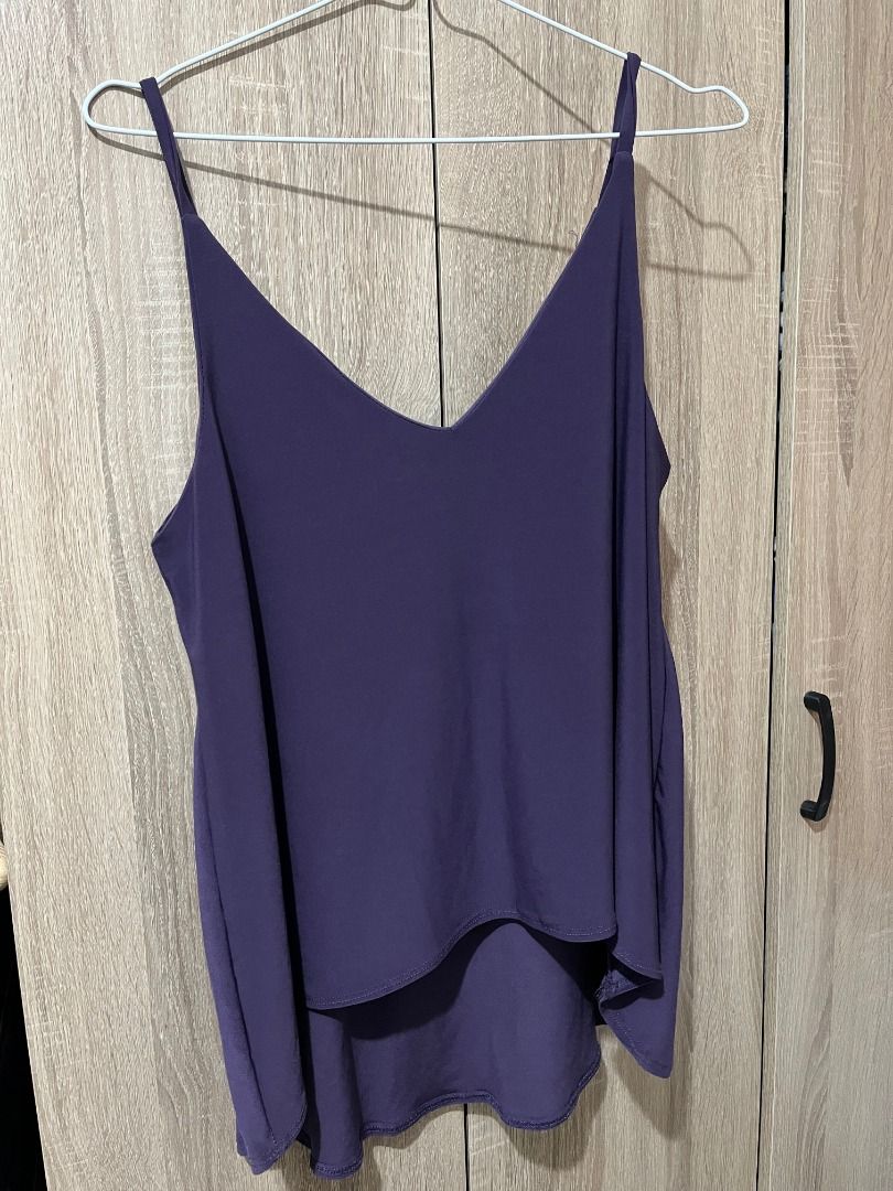 Purple V-neck Cami Top (Category: Sleeveless) located in Cabanatuan. Submitted by declutteringhaven (Listing ID 1443934033, Image 1). Description: - Purple cami top - V-neckline - Thin straps - Flowy, layered hem - Lightweight and comfortable fabric - Perfect for layering or wearing on its own - Easy to dress up or down.