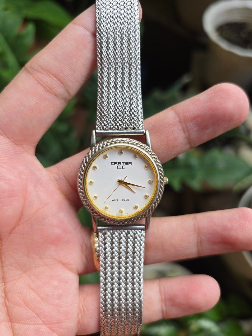 Q&Q Water Resist Analog Watch (Category: Women's Watches) located in Manila. Submitted by timearcph (Listing ID 1443974306, Image 3). Description: This is a Citizen Q&Q Crater quartz watch featuring a gold-tone dial bezel, a white face with gem-style markers, and a silver-tone metal strap.Brand: Q&Q, a subsidiary brand of Citizen.Model Line: Crater series.Features: Water-resistant design, quartz movement, and stainless steel case back..