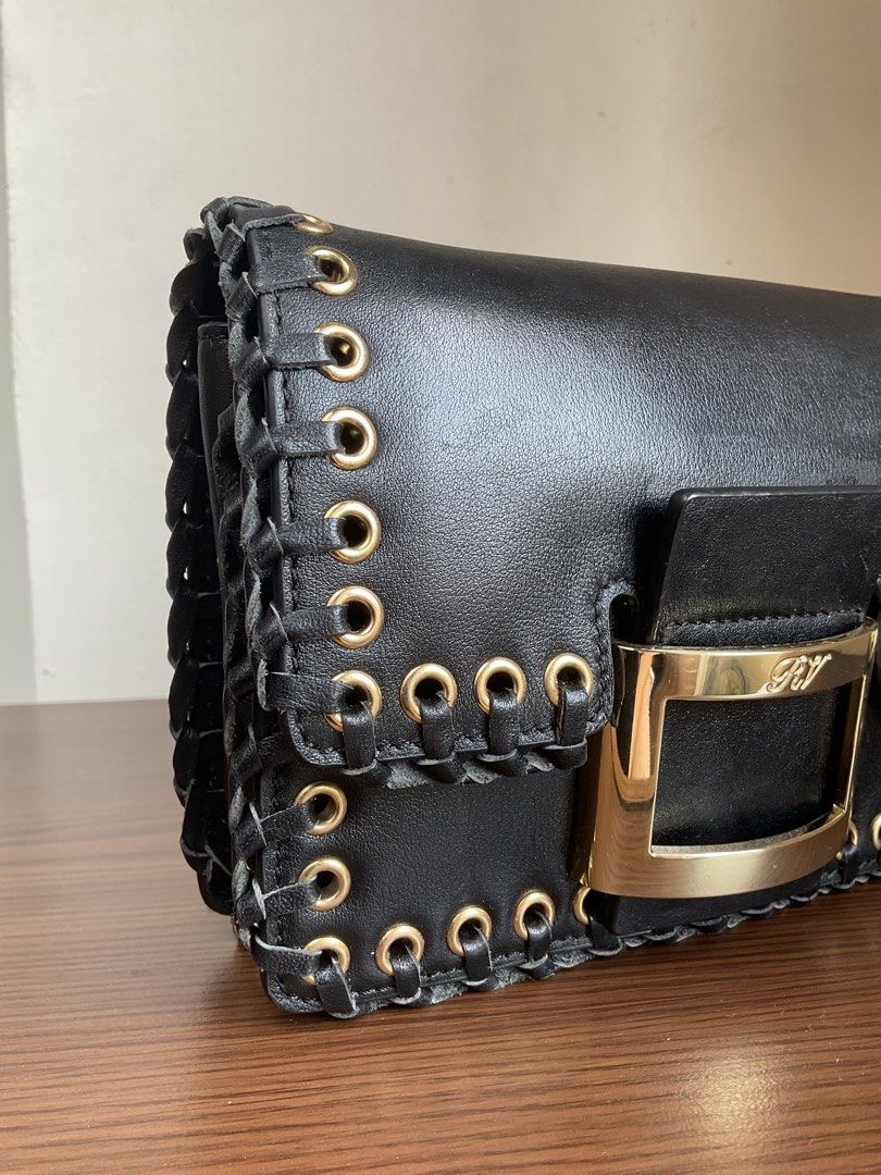 Authentic Roger Vivier bag (Category: Luxury Bags & Wallets) located in Caloocan City. Submitted by siftedthriftedph (Listing ID 1444008215, Image 3). Description: - Rockstar chic vibes - Est. Retail $1,650 - Whipstitch borders made from genuine leather with gold tone hardwares - Leather inner lining - L-7.75in x H-5.75in - Excellent condition.