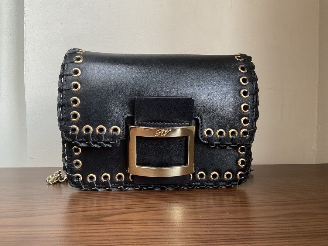 Authentic Roger Vivier bag (Category: Luxury Bags & Wallets) located in Caloocan City. Submitted by siftedthriftedph (Listing ID 1444008215, Image 2). Description: - Rockstar chic vibes - Est. Retail $1,650 - Whipstitch borders made from genuine leather with gold tone hardwares - Leather inner lining - L-7.75in x H-5.75in - Excellent condition.
