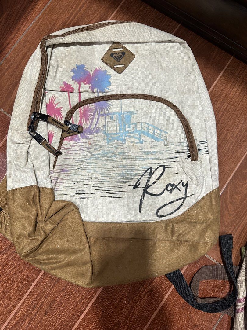 Roxy Beach Scene Canvas Backpack (Category: Backpacks) located in Paranaque City. Submitted by thriftclothing101 (Listing ID 1443968746, Image 1). Description: - Roxy backpack with a cool beach scene graphic - Tan and off-white canvas material - Adjustable straps for comfort - Perfect for everyday use or beach trips - Please check photos for detailed condition.