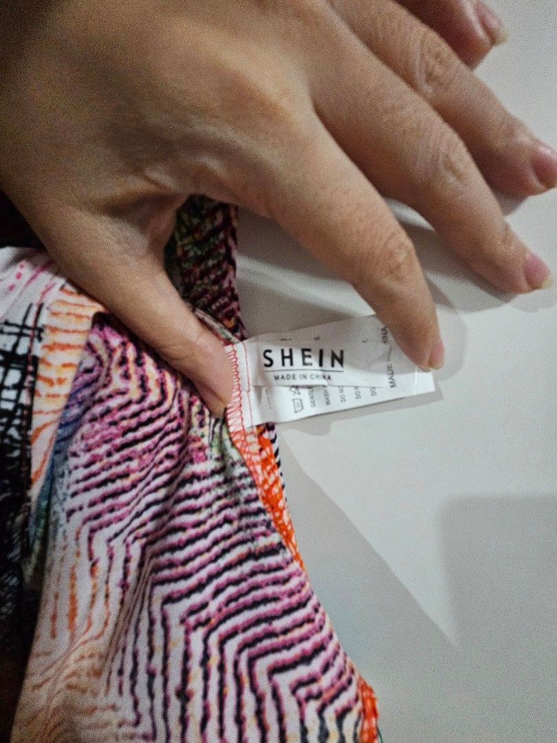 SHEIN Colorful Abstract Print Button-Up Shirt (Category: Blouses) located in Caloocan City. Submitted by rm.diaz (Listing ID 1444059892, Image 2). Description: - Vibrant abstract print SHEIN top - Button-up front - Collared neckline - Textured fabric feel - Adds a pop of color to any outfit - Versatile for casual or dressed-up looks.