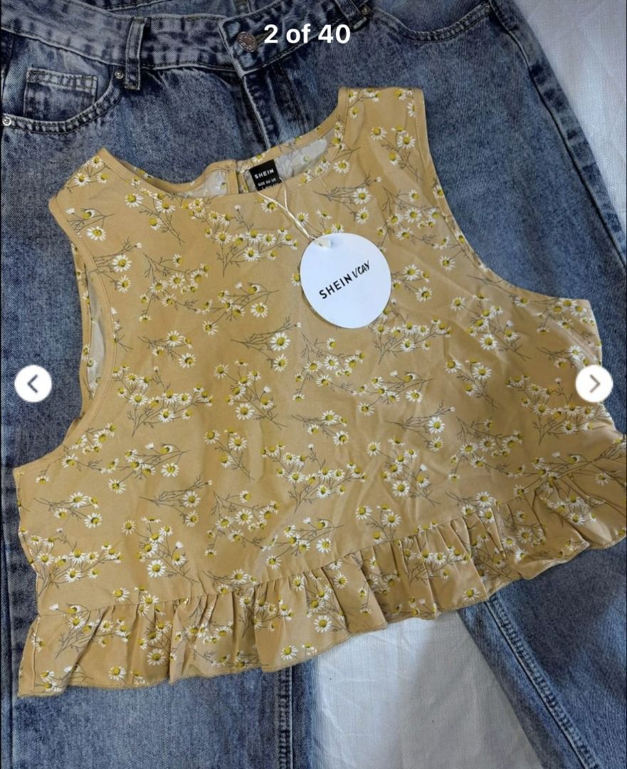 SHEIN Daisy Print Cropped Top with Ruffle Hem (Category: Blouses) located in Cabanatuan. Submitted by declutteringhaven (Listing ID 1443933450, Image 2). Description: - Cute cropped top from SHEIN - Size: L - Color: Tan with daisy print - Design: Sleeveless with ruffled hem - Closure: Keyhole at the back - Style tip: Pairs well with jeans.
