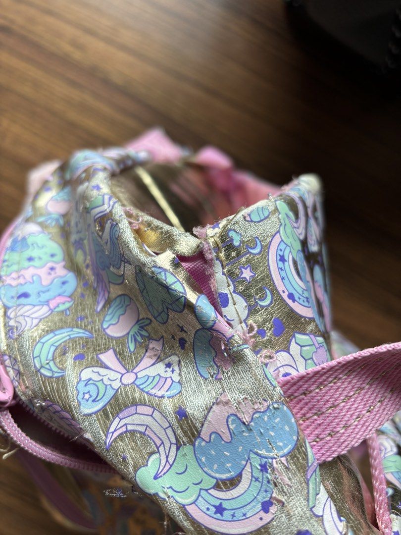 Smiggle Unicorn Cupcake Backpack Gold Pink Heart (Category: Backpacks) located in Makati City. Submitted by homeandbaby (Listing ID 1443929356, Image 2). Description: - Adorable Smiggle backpack with a fun unicorn and cupcake print. - Stylish gold and pink color scheme. - Features a cute, shiny heart pocket on the front. - Interior is clean and includes practical dividers. - Ideal for school, kindergarten, or everyday adventures..