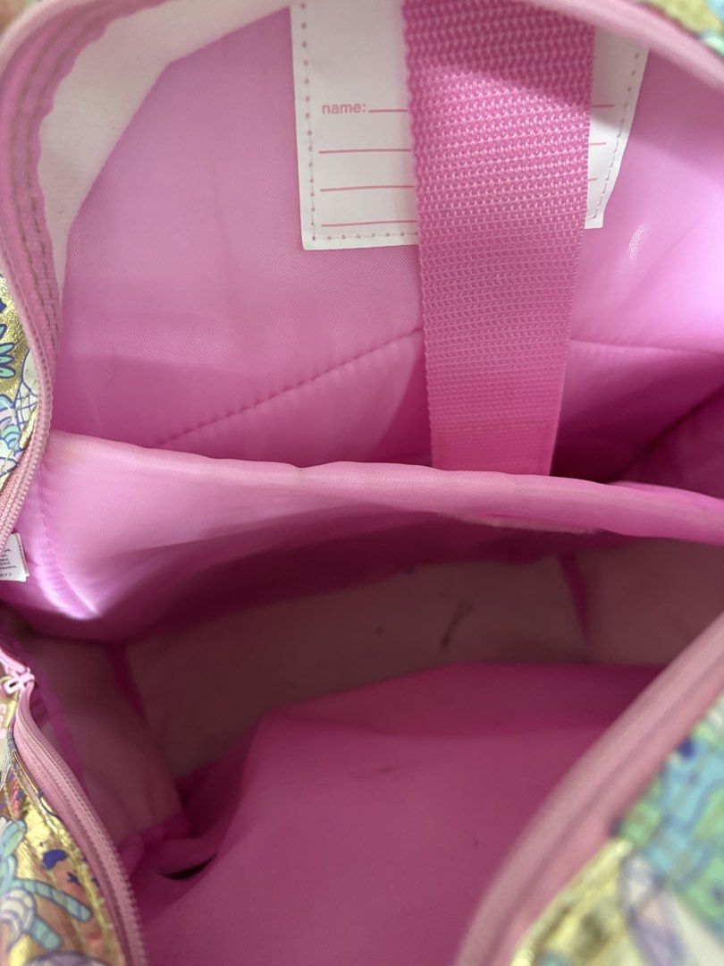 Smiggle Unicorn Cupcake Backpack Gold Pink Heart (Category: Backpacks) located in Makati City. Submitted by homeandbaby (Listing ID 1443929356, Image 3). Description: - Adorable Smiggle backpack with a fun unicorn and cupcake print. - Stylish gold and pink color scheme. - Features a cute, shiny heart pocket on the front. - Interior is clean and includes practical dividers. - Ideal for school, kindergarten, or everyday adventures..