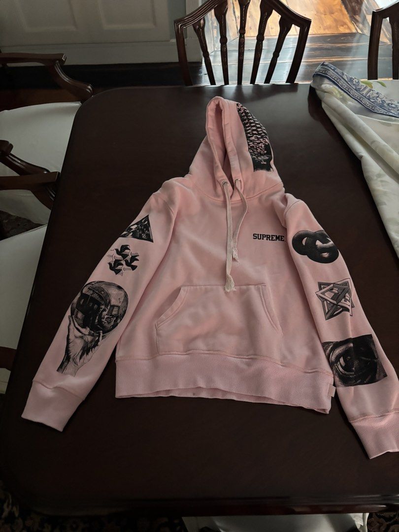 Supreme Pink Graphic Hoodie (Category: Hoodies) located in Manila. Submitted by rosemarywstn (Listing ID 1443924290, Image 1). Description: - Pink Supreme hoodie - Graphic prints on sleeves, front, and back - Noticeable wear at the drawstring.