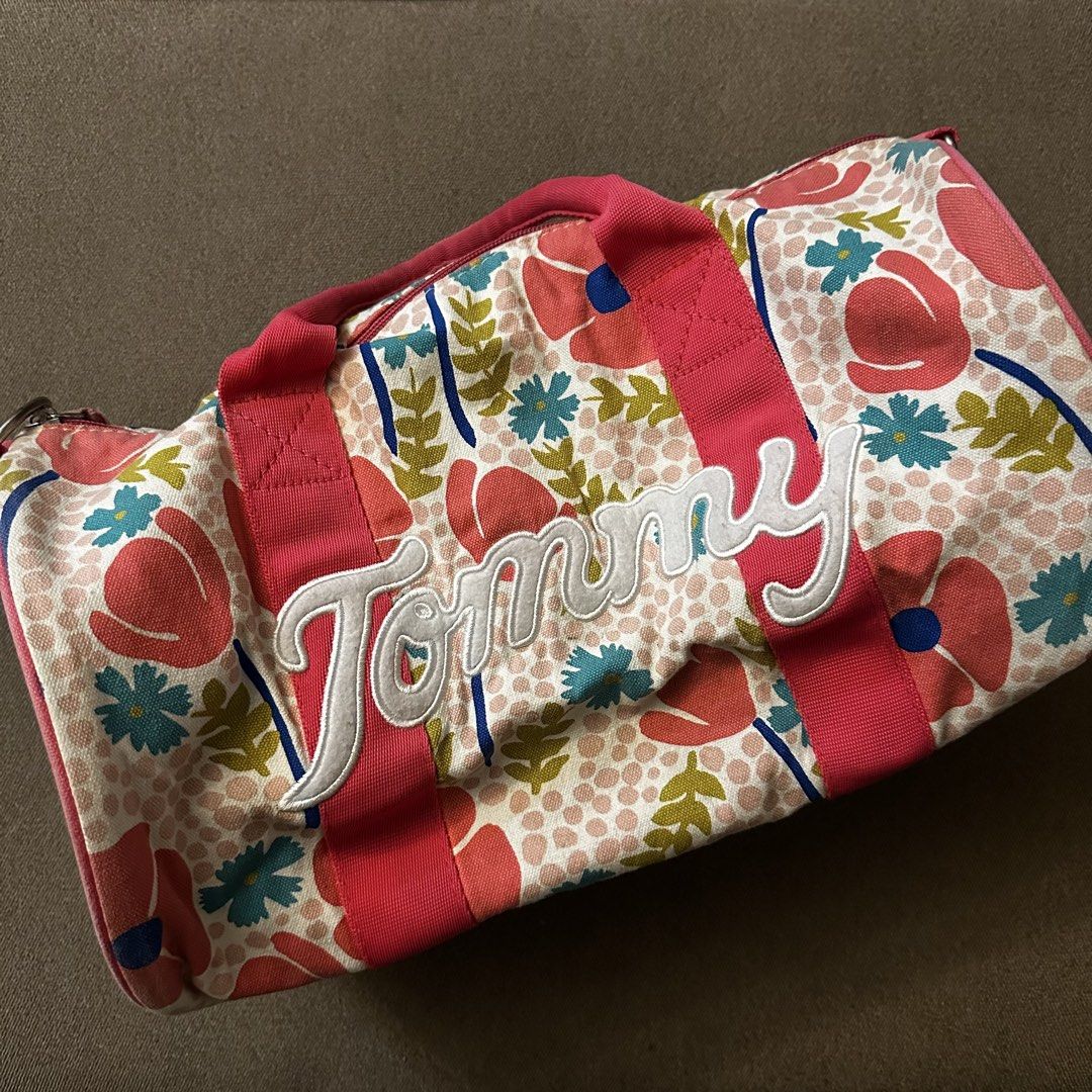 Tommy Hilfiger floral duffel bag (Category: Cross-body Bags) located in Batangas. Submitted by veevasclutter (Listing ID 1444064496, Image 1). Description: • floral/tropical print with pink trim and handles • made of cotton • for trainings and beach getaways.