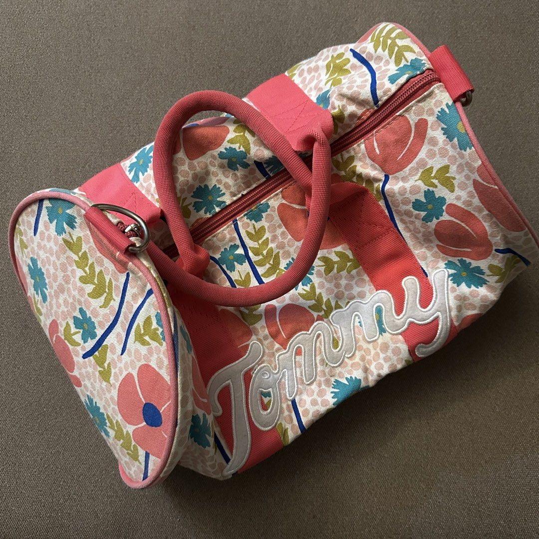 Tommy Hilfiger floral duffel bag (Category: Cross-body Bags) located in Batangas. Submitted by veevasclutter (Listing ID 1444064496, Image 2). Description: • floral/tropical print with pink trim and handles • made of cotton • for trainings and beach getaways.