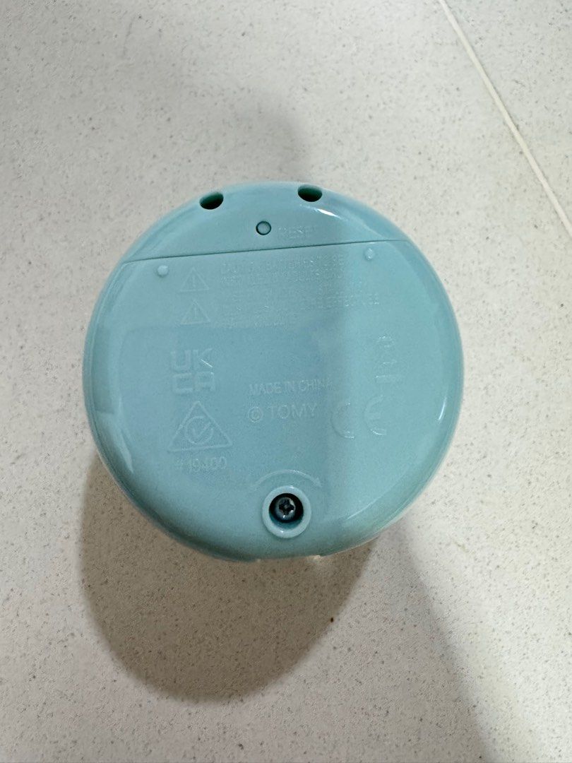 Tomy PuniRunes Virtual Pet Tamagotchi Style Toy (Category: Interactive Toys) located in Singapore. Submitted by pigshi (Listing ID 1443921110, Image 2). Description: - Light blue PuniRunes virtual pet toy - Made by Tomy - Screen displays a low battery icon with an X - Requires batteries (not included) - Fun handheld electronic game.