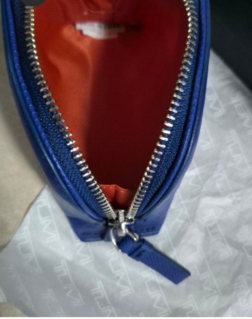 TUMI MONOGRAMMED "CD" GENUINE LEATHER COSMETIC CASE, BLUE (Category: Luxury Bags & Wallets) located in Quezon City. Submitted by stuffiesetc (Listing ID 1443996329, Image 3). Description: TUMI MONOGRAMMED "CD" GENUINE LEATHER COSMETIC CASE, BLUE guaranteed authentic. brand new in box. just came in from the u.s. Retails originally for Php11,500. material: geniune leather color: blue outer, orange interior monogrammed "CD" zipper closure.