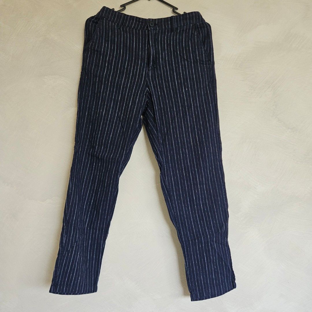 UNIQLO Navy Blue Striped Pants (Category: Other Bottoms) located in Quezon City. Submitted by k_closetsale (Listing ID 1444108758, Image 1). Description: - Navy blue pants with subtle thin white stripes - Relaxed fit for ultimate comfort - Features a drawstring or elastic waistband for a customizable fit - Convenient side pockets - Lightweight fabric, perfect for warm weather or lounging - Versatile for casual outings or staying in.