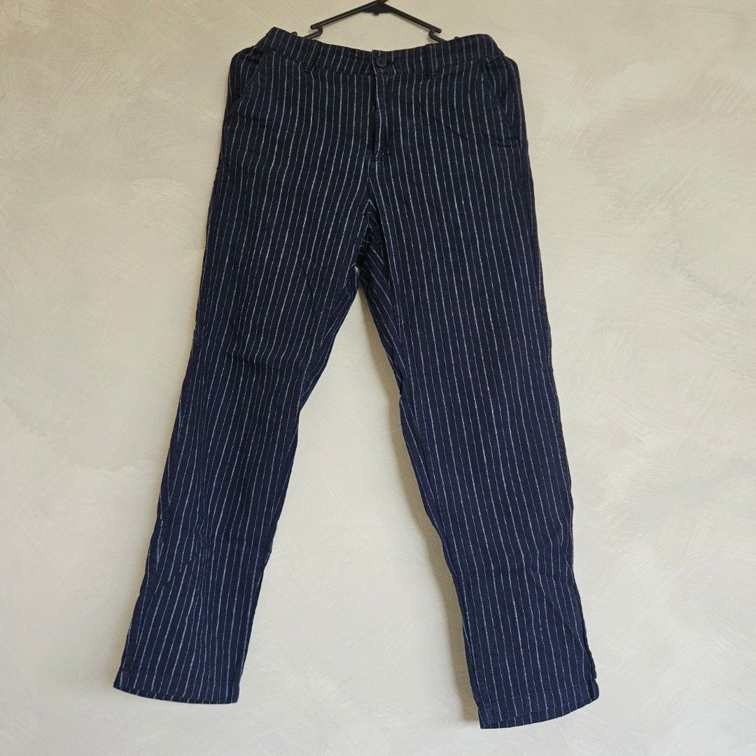 UNIQLO Navy Blue Striped Pants (Category: Other Bottoms) located in Quezon City. Submitted by k_closetsale (Listing ID 1444108758, Image 2). Description: - Navy blue pants with subtle thin white stripes - Relaxed fit for ultimate comfort - Features a drawstring or elastic waistband for a customizable fit - Convenient side pockets - Lightweight fabric, perfect for warm weather or lounging - Versatile for casual outings or staying in.