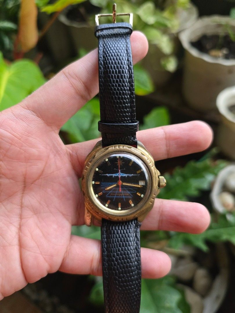 Vostok Komandirskie watch (Category: Women's Watches) located in Manila. Submitted by timearcph (Listing ID 1443975374, Image 2). Description: This Vostok Komandirskie watch features a unique dial depicting a Soviet strategic bomber aircraft.Brand: VostokModel: Komandirskie ("Commander")Features: Includes a calendar function and a mechanical manual-winding movement.Design: The dial showcases a red and blue aircraft silhouette over a blue grid pat