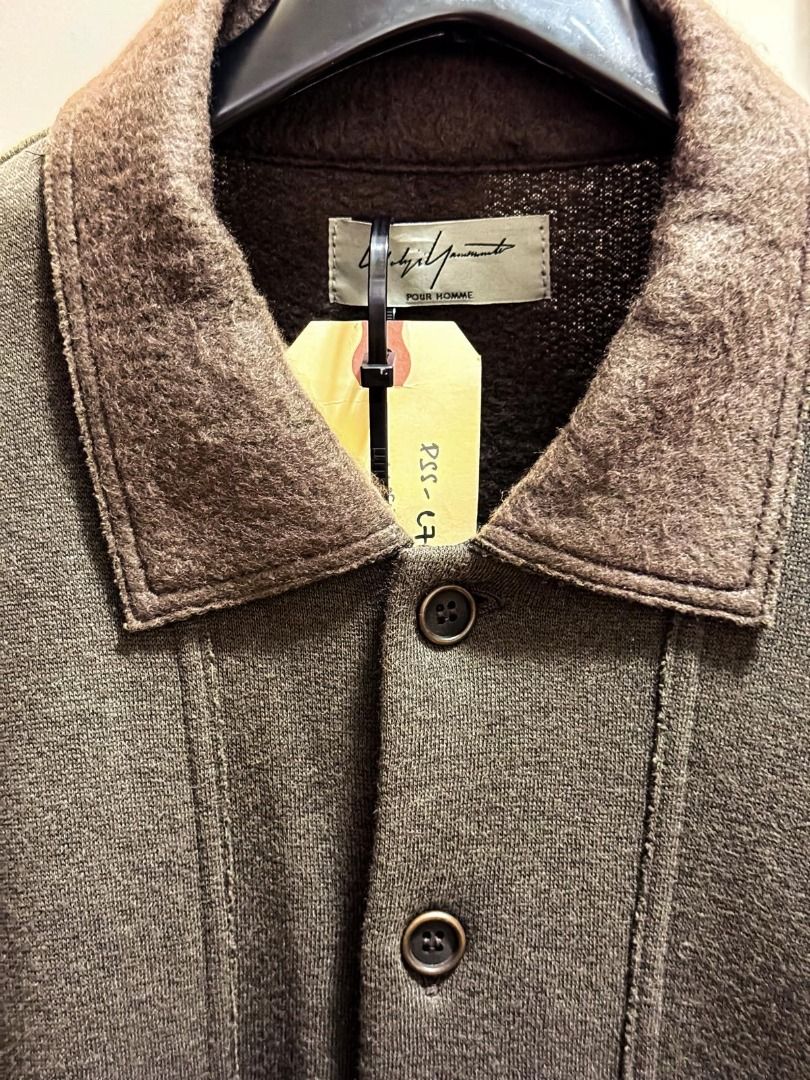 Yohji Yamamoto POUR HOMME two toned olive and brown long coat Made in Japan (Category: Apparel) located in Singapore. Submitted by ernestlow (Listing ID 1443918758, Image 3). Description: - Yohji Yamamoto POUR HOMME Jacket - Size: 3 - Color: Dark Olive Green - Made in Japan - Button-up front with collar - Two front pockets - Long sleeves - Material: 62% Cotton, 28% Polyester, 10% Rayon - Care: Hand wash only (Note: shape may slightly alter after 