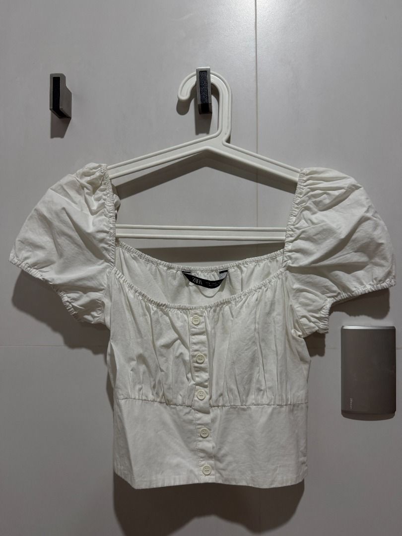 Zara White Square Neck Puff Sleeve Button Up Crop Top (Category: Blouses) located in Mandaluyong City. Submitted by kayechx (Listing ID 1444076342, Image 1). Description: - White Zara crop top - Square neckline - Short puff sleeves - Button-up front - Smocked elasticated back for a snug fit - Pairs well with high-waisted bottoms - Comfortable and stylish for casual wear can give 10% discount if you purchase 3 or more items from me.