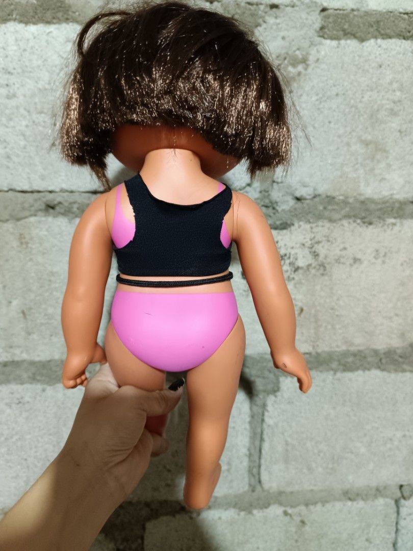 2003 Mattel Dora the Explorer Doll (Category: Kids Toys) located in Manila. Submitted by caaths_collection (Listing ID 1444173349, Image 2). Description: - Dora the Explorer doll from 2003 - Manufactured by Mattel - Features brown hair and brown eyes - Dressed in a cute black and pink swimsuit - Minor scuffs present on the feet - Ideal for Dora collectors or for playtime fun - preloved.