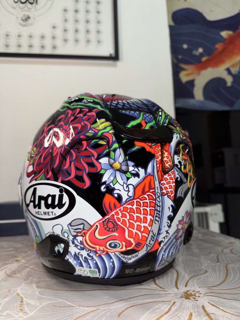 Arai VZ-Ram Tattoo Series Helmet (Category: Motorcycle Apparel) located in Singapore. Submitted by n.nabila25 (Listing ID 1444232245, Image 3). Description: - Arai VZ-Ram Helmet - Unique Japanese tattoo design (koi fish & waves) - Clear visor included - Stylish and functional for riders - Stand out on your rides! - Size M (Used 4 times only!) - Selling @ 750 , Able to nego! offer me your best price, but no lowball!.