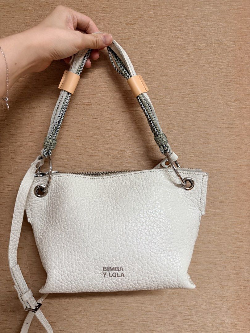 BIMBA Y LOLA White Leather Shoulder Bag (Category: Luxury Bags & Wallets) located in Mandaluyong City. Submitted by mtdc1 (Listing ID 1444271555, Image 1). Description: - White leather shoulder bag by BIMBA Y LOLA - Textured leather finish - Features a braided strap with leather accents - Secure zipper closure - Comes with an additional longer, adjustable strap - Ideal for everyday wear.