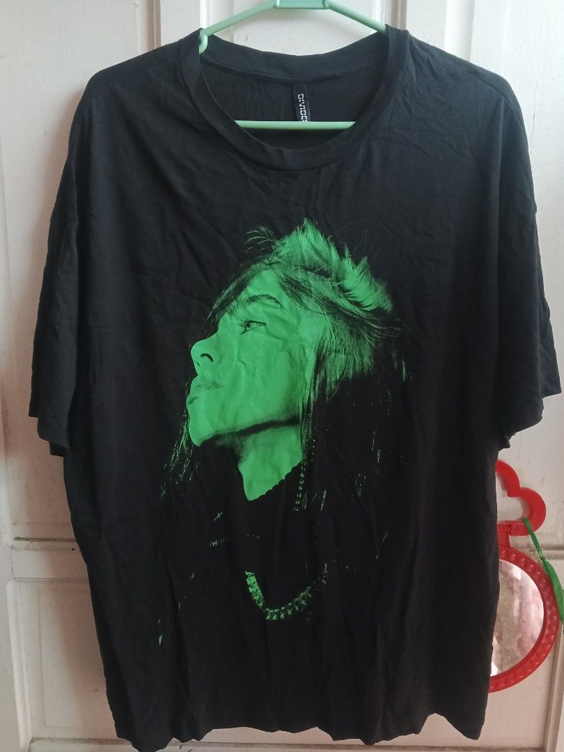Black Billie Eilish Graphic T-Shirt (Category: Tshirts & Polo Shirts ) located in Quezon City. Submitted by wheelsonmeals (Listing ID 1444127988, Image 2). Description: 24x28. 550 Black t-shirt featuring a cool green graphic of Billie Eilish on the front. - Back of the shirt has green text that reads "BILLIE EILISH". - Brand: Divided. - Ideal for any Billie Eilish fan..