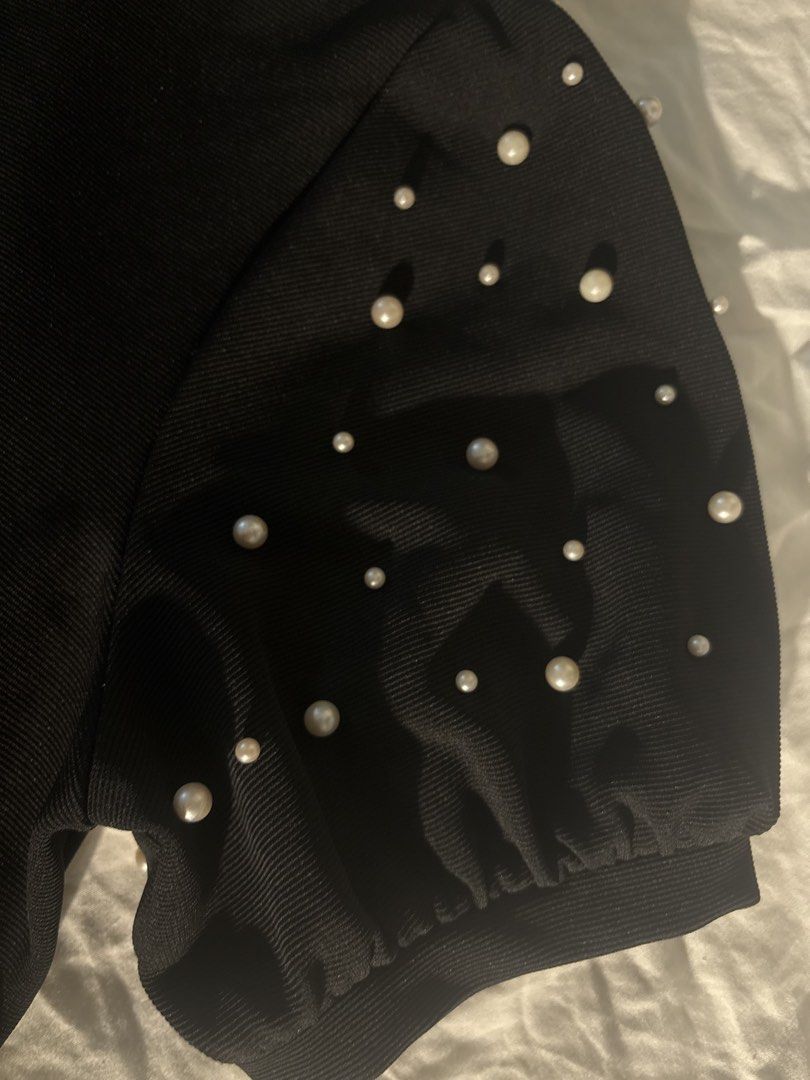 Black Pearl Embellished Puff Sleeve Top (Category: Blouses) located in General Trias. Submitted by misousoup (Listing ID 1444285589, Image 2). Description: - stylish puff sleeves with pearl embellishments - Chic mock neck design - Fits Large - RFS: Decluttering.