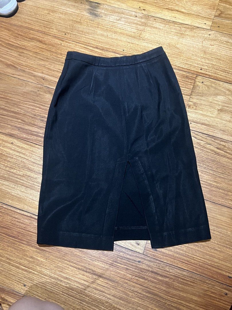 Black pencil skirt with diagonal zipper (Category: Skirts) located in Pasig City. Submitted by tiny_studios (Listing ID 1444202430, Image 1). Description: mom’s old work clothes - mango women’s - Size M - no damages - vintage look - get 3 items below 200, get cheapest one for free.