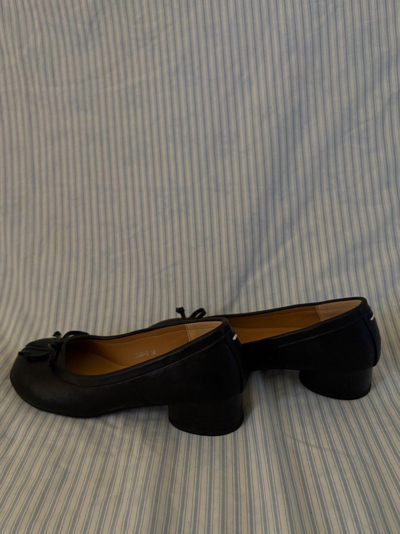 black tabi heels with bow detail (Category: Flats & Sandals) located in San Antonio. Submitted by lostnfoundph (Listing ID 1443996688, Image 1). Description: - Classic black leather tabi flats - Features a charming small bow on the toe - Comfortable low block heel for all-day wear - Easy slip-on style for convenience - A versatile staple for any fashion-forward wardrobe -Used once only.