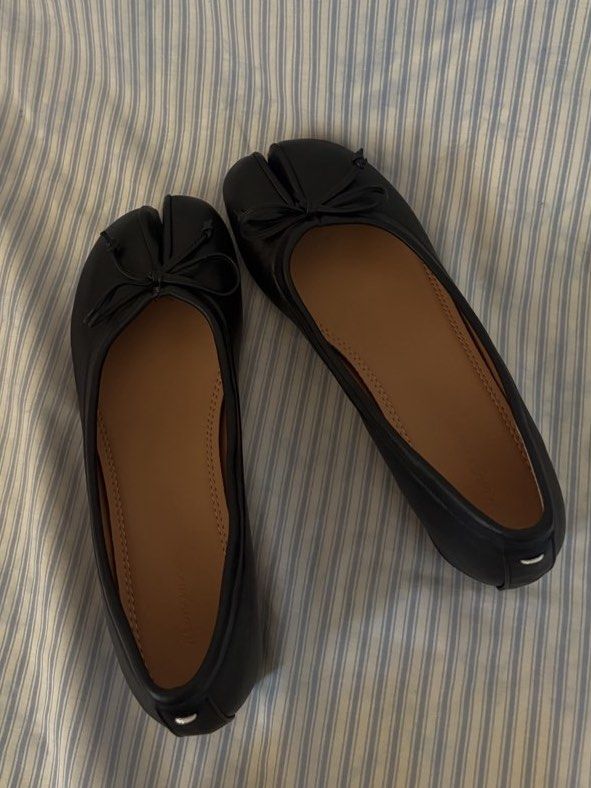 black tabi heels with bow detail (Category: Flats & Sandals) located in San Antonio. Submitted by lostnfoundph (Listing ID 1443996688, Image 2). Description: - Classic black leather tabi flats - Features a charming small bow on the toe - Comfortable low block heel for all-day wear - Easy slip-on style for convenience - A versatile staple for any fashion-forward wardrobe -Used once only.