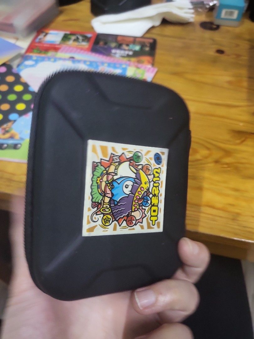 Black Zippered Storage Case with Anime Sticker (Category: Storage Boxes & Baskets) located in Caloocan City. Submitted by lynette1977 (Listing ID 1444276938, Image 3). Description: - Durable black hard shell case - Secure zipper closure - Interior mesh pocket for organization - Elastic strap to keep items in place - Adorable anime sticker on the front - Perfect for storing small electronics, cables, earbuds, or other accessories - Compact size: a