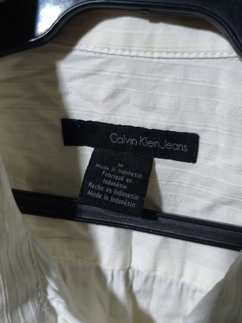 Calvin Klein Jeans Longsleeve Polo (Category: Longsleeves) located in Quezon City. Submitted by _clxde (Listing ID 1444188350, Image 2). Description: - Worn Once - Great for Casual and Formal Attire - Cream/Off-white Color - Made from 97% Cotton and 3% Elastane - Size Medium on Tag Sleeve Length: 26.4" Length: 27" Width: 26" (From Pit to Pit).