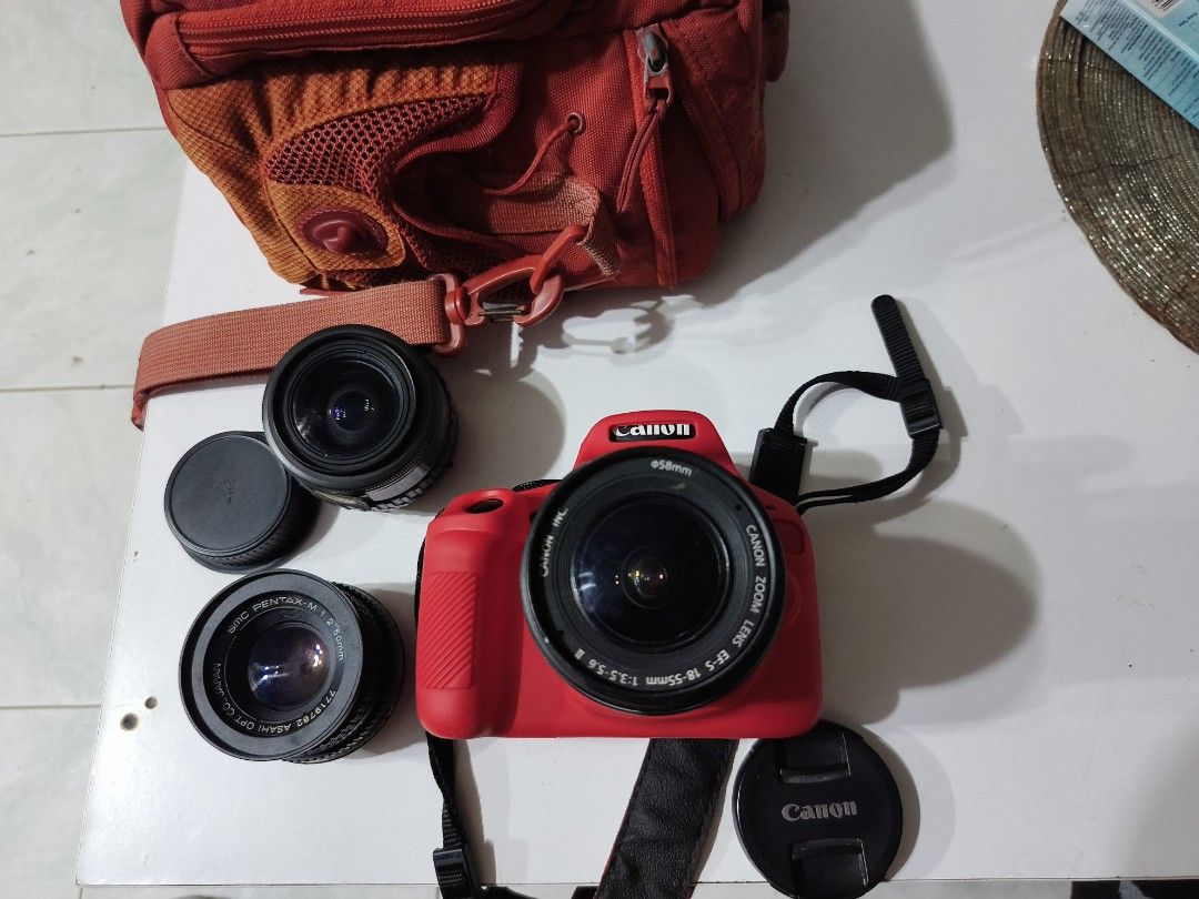 Canon EOS 1300d, with bag and 2 extra lenses (Category: Cameras) located in Rizal. Submitted by ramon100x (Listing ID 1444118197, Image 2). Description: - Red Canon EOS Digital Camera - Two Lenses Included - Lens Caps - Red Canon EOS Camera Bag - Ideal for beginners or as a backup camera - Ready for your next adventure - with 2 batteries and charger and 16 GB original memory card, - no issue makinis pa.