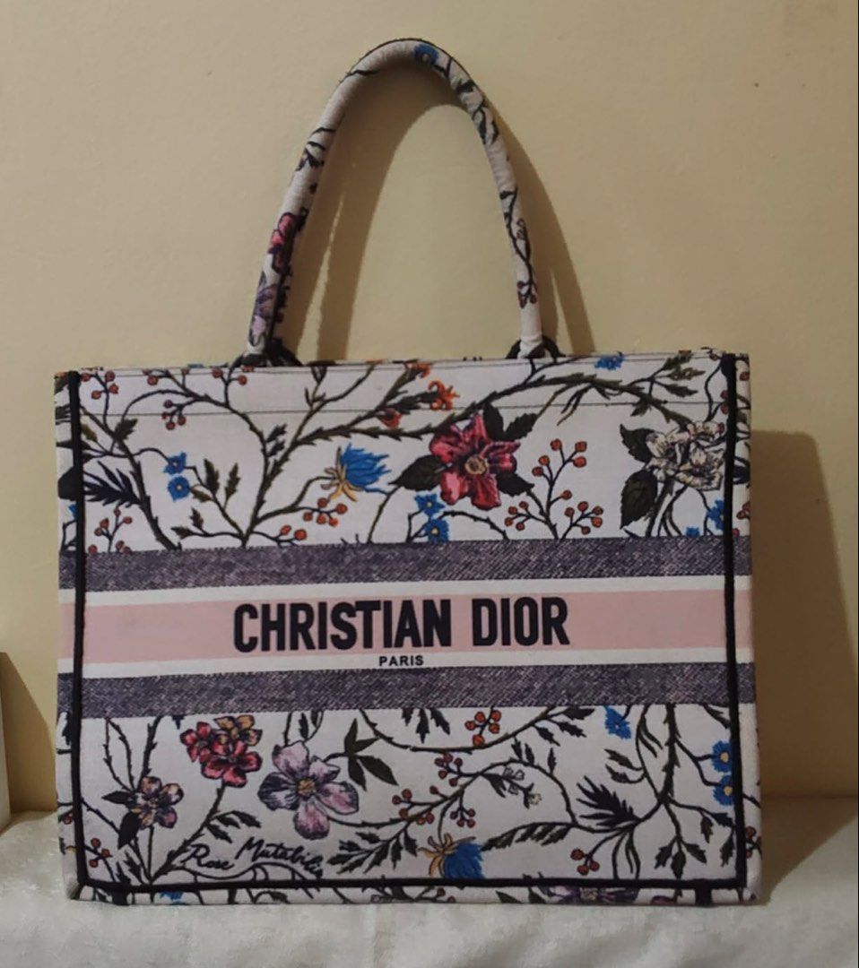 Christian Dior Book Tote Bag (Category: Luxury Bags & Wallets) located in Manila. Submitted by elviraarab79849 (Listing ID 1444171596, Image 1). Description: Selling this beautiful Christian Dior Rosa Mutabilis Embroidered Canvas Book Tote Bag. This design features an intricate multi-colored botanical floral motif and the prominent “CHRISTIAN DIOR PARIS” signature band across the center.A perfect, spacious everyday or travel bag that easily fits 
