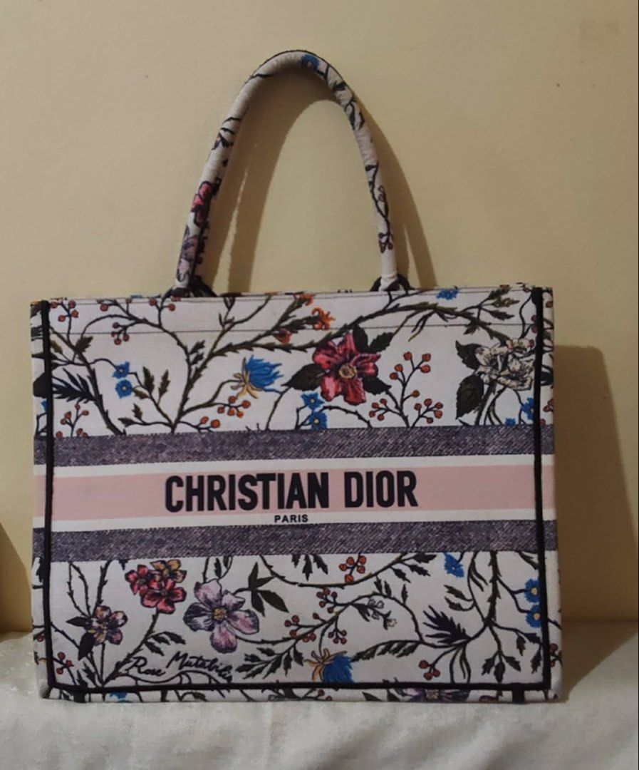 Christian Dior Book Tote Bag (Category: Luxury Bags & Wallets) located in Manila. Submitted by elviraarab79849 (Listing ID 1444171596, Image 2). Description: Selling this beautiful Christian Dior Rosa Mutabilis Embroidered Canvas Book Tote Bag. This design features an intricate multi-colored botanical floral motif and the prominent “CHRISTIAN DIOR PARIS” signature band across the center.A perfect, spacious everyday or travel bag that easily fits 