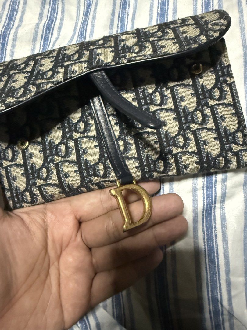 Christian Dior Saddle Pouch and Wallet Set (Category: Luxury Bags & Wallets) located in Pateros City. Submitted by thedeclutteristph (Listing ID 1444175691, Image 3). Description: - Store bought Dior Saddle pouch with chain - complete set - Store price is P105k - Classic Dior Oblique canvas - Gold hardware details - Detachable chain strap included - Ideal for carrying essentials - Versatile for day or night use.