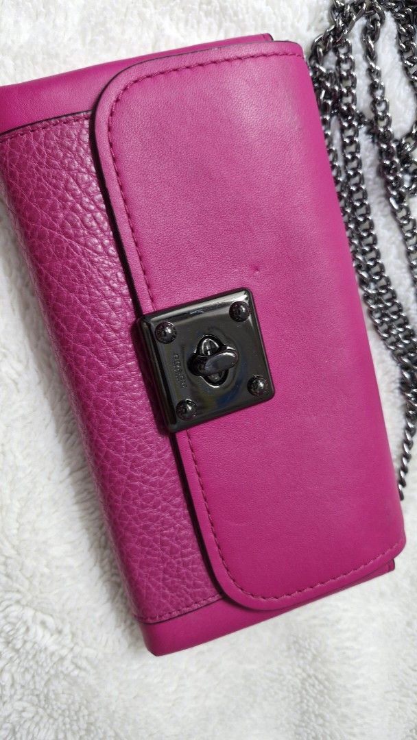 Coach Chain Wallet (Category: Luxury Bags & Wallets) located in Paranaque City. Submitted by pumpkinpixie (Listing ID 1444253040, Image 2). Description: - Fuchsia Coach chain wallet - Textured leather front, smooth leather top - Chain strap - Clasp closure - Multiple compartments and zippered pocket - Authentic Coach logo inside.