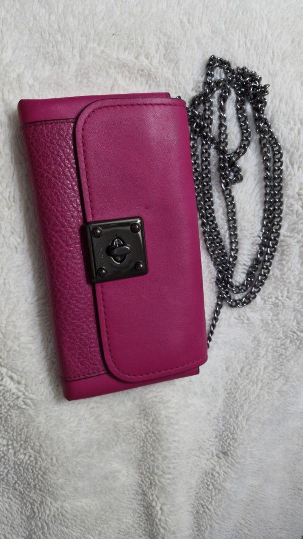 Coach Chain Wallet (Category: Luxury Bags & Wallets) located in Paranaque City. Submitted by pumpkinpixie (Listing ID 1444253040, Image 1). Description: - Fuchsia Coach chain wallet - Textured leather front, smooth leather top - Chain strap - Clasp closure - Multiple compartments and zippered pocket - Authentic Coach logo inside.