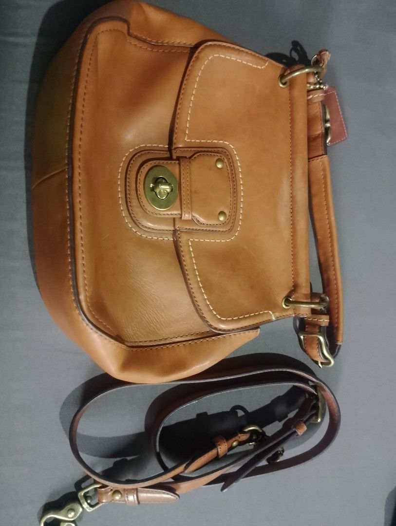 Coach Leather Handbag with Tassel Charm (Category: Luxury Bags & Wallets) located in Manila. Submitted by silenttiger-e0e3 (Listing ID 1444162647, Image 3). Description: - Genuine brown leather Coach bag - Eye-catching colorful striped interior lining - Includes a detachable shoulder strap for versatile wear - Adorned with a stylish tassel charm and signature Coach logo tag - Secure turn-lock closure - Minor signs of wear on the leather tag, over